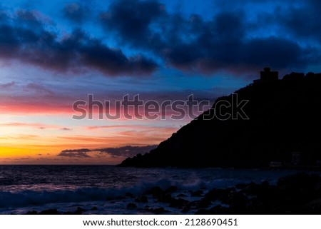 A castle by the sea silhouette at sunset
