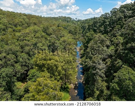 Drone aerial of Broken River flowing through dense national park. Eungella, Mackay, Queensland, Australia.
