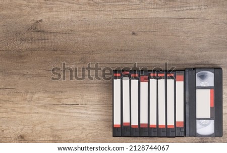 Video tapes grouped on a wooden background. Copy Space. Retro concept and 90's nostalgia.