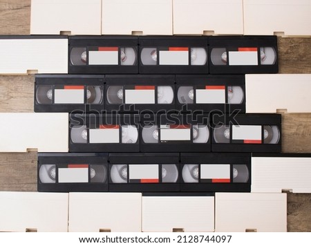 Video tapes grouped on a wooden background. Copy Space. Retro concept and 90's nostalgia.