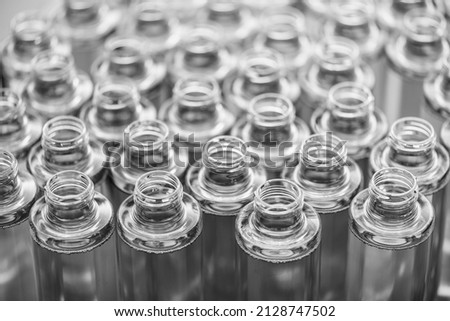 group of empty plastic bottles on the assembly line