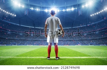 Football player with ball in the stadium, 3d rendering Royalty-Free Stock Photo #2128749698