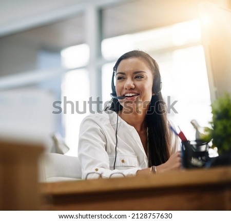 Be productive in helping customers. Shot of a female agent working in a call centre. Royalty-Free Stock Photo #2128757630