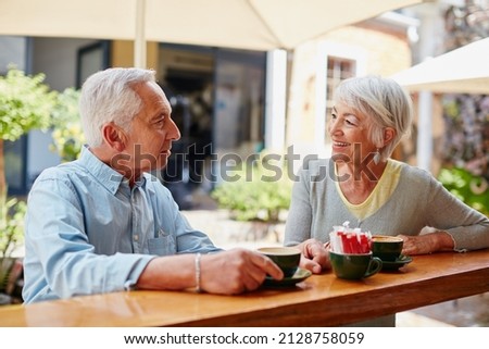 Having coffee after meeting at an online dating site. Shot of a senior couple having coffee at a cafe. Royalty-Free Stock Photo #2128758059