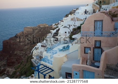 Oia town on Santorini island, Greece. Traditional and famous houses with blue domes over the Caldera, Aegean sea