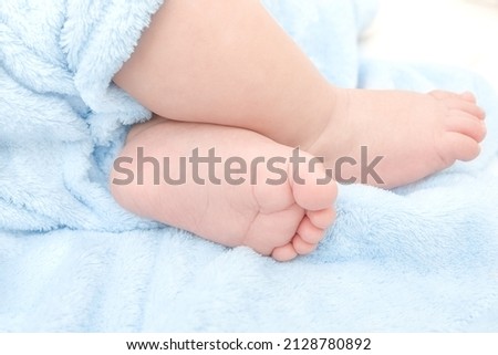 cute baby boy feet on a blue blanket