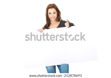 Portrait of young happy woman with blank board