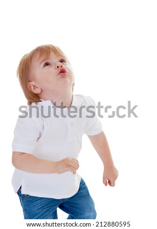 Little boy in white shirt looking up on a white background.The concept of a child's learning and development.