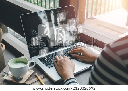 Enterprise Resource Planning ERP, document management concept with icons on virtual screen, Business woman working with laptop computer with icons on virtual screen on office desk.
