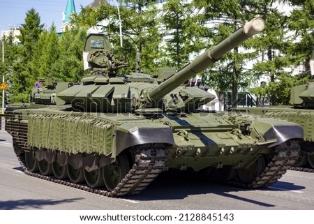 Military tanks on the street of city. The concept of fighting against military action. Royalty-Free Stock Photo #2128845143