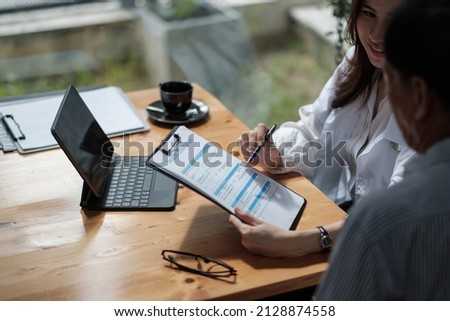 Female health insurance broker presenting his insurance benefits to businessman fill out insurance policy. To prevent future incidents. Royalty-Free Stock Photo #2128874558