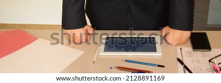 Businessman beating his fists on the table after checking business data. Banner