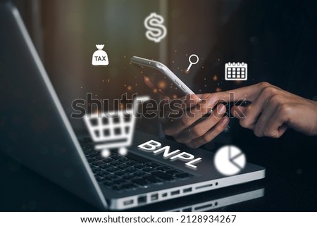 Businesswomen holding a smartphone with icons of BNPL with online shopping icons technology. BNPL Buy now pay later online shopping concept.
 Royalty-Free Stock Photo #2128934267