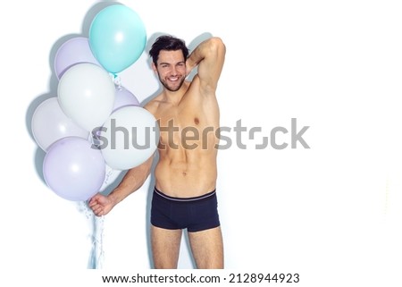 Funny Caucasian Man Impressed Something Positive While on Party Or Club Presentation Wearing Contrasty Underware Outfit Holding Colorful Airballoons. Horizontal Image