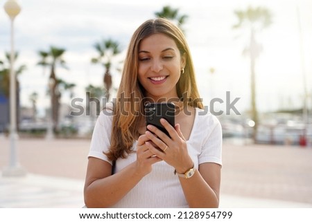 Tourist girl looking for hotel on mobile phone. Traveler woman using mobile phone booking a room for the night. Last minute travels concept. Royalty-Free Stock Photo #2128954799