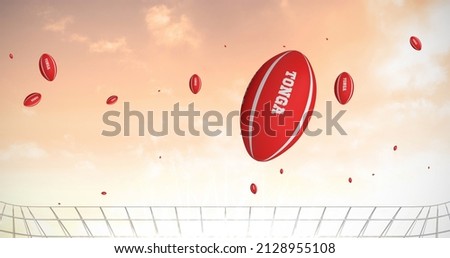 Image of red rugby balls with tonga text at stadium. sport and competition concept digitally generated image.