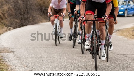 road cycling race. Group of people doing sport cycling. unrecognizable men using racing bike in a cycling event. concept sport. Royalty-Free Stock Photo #2129006531
