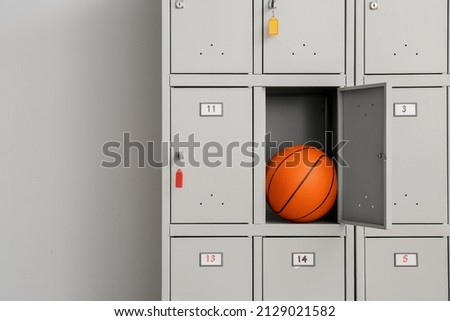 Locker with sport equipment in change-room Royalty-Free Stock Photo #2129021582