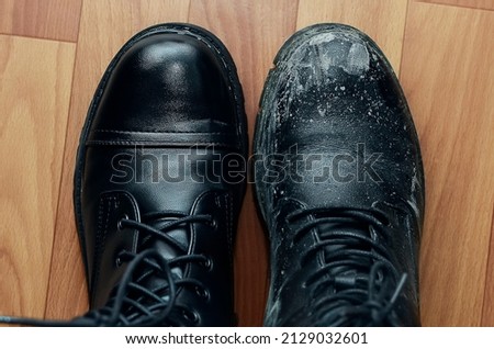 A clean shoe stands next to a dirty one. Royalty-Free Stock Photo #2129032601