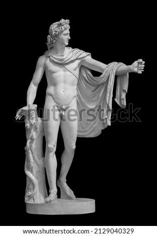 God Apollo sculpture. Ancient Greek god of Sun and Poetry Plaster copy of a marble statue isolated on black with clipping path