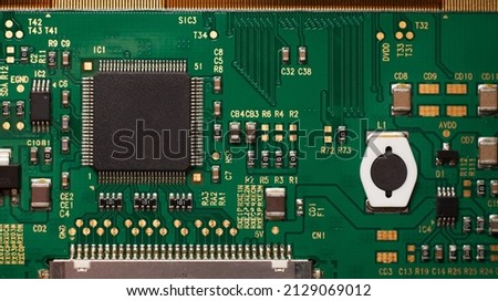 Macro photo of a green computer printed circuit board with selective focus on an blank chip. Royalty-Free Stock Photo #2129069012