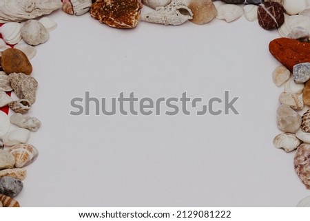 a frame made of seashell, a frame made of seashell with free space under it on a white background, a summer concept
