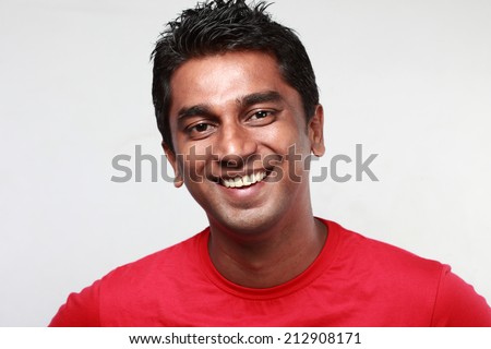 Portrait of a casually dressed  smiling Indian young man Royalty-Free Stock Photo #212908171