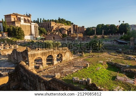 The Roman Forum, a popular tourist attraction surrounded by the ruins of several ancient government buildings is located at the center of the city of Rome, pictured here during a summer day.  