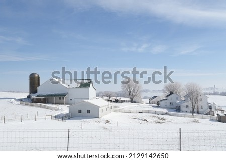A country farm scene covered in snow