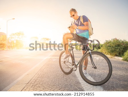 Sportive man with bicycle at sunset 