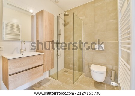 modern bathroom with white brown appliances Royalty-Free Stock Photo #2129153930