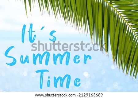 Its summer time message written in elegant font on the background with palm leaf and blue sea. Holiday concept and advertising of tour agency.  Royalty-Free Stock Photo #2129163689