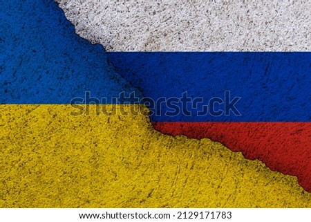 Ukraine and Russia national flags on a grunge texture symbolising war and conflict.