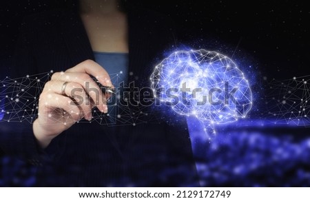 The modern concept of the cyberbrain. Hand holding digital graphic pen and drawing digital hologram Brain sign on city dark blurred background. Virtual Reality technology.