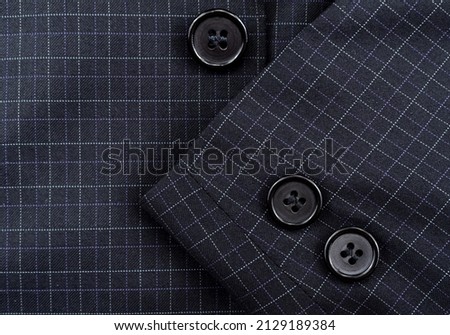 Sleeve with buttons on the men's check suit. Men's suit. Part, item of clothing Royalty-Free Stock Photo #2129189384