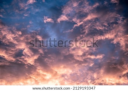 Celestial Abstract real beauty background. Dark purple blue pink bright fantastic sunset reflections sky cumulus clouds. Tragic gloom, evening time, cumulative cloudiness. Copy space design wallpaper