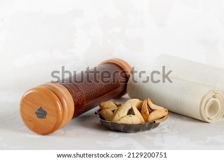 Scroll of Esther and haman's ears cookies. Hebrew inscription Megillat Esther. Israeli holiday Purim Royalty-Free Stock Photo #2129200751