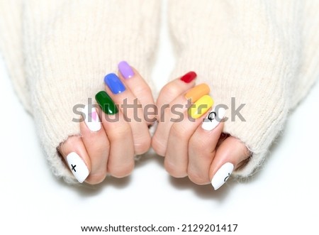 Woman hands with LGBT pride rainbow flag colours manicure isolated on white background. Royalty-Free Stock Photo #2129201417