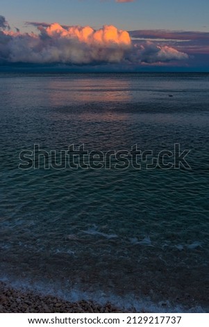 beautiful pink and lilac clouds sunset over the sea