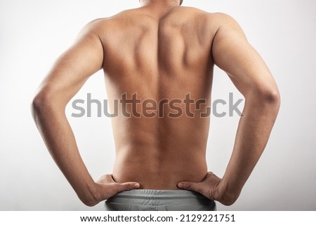 Scapula injury , shoulder blades inflammation, back pain. Indian muscular man feeling pain on shoulder blades. Royalty-Free Stock Photo #2129221751