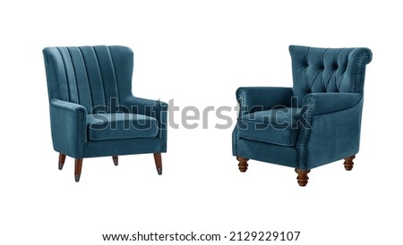 Two classic quilted armchairs art deco style in navy blue velvet with wooden legs isolated on white background with clipping path. Series of furniture