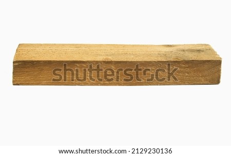 A long and narrow wooden beam isolated on a white background.Roughly processed wooden beam.Cracks and resin drips on the wooden block.Copy space.