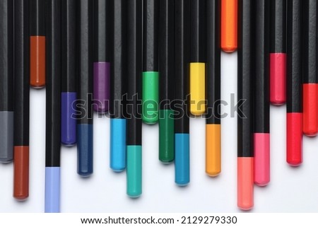 A lot of color pencils next to each other on isolated white background. Colorful illustration photo for modern decoration poster, design picture or inspiration for creativity.