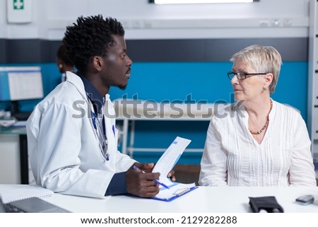 General practitioner informing ill patient of consultation results and treatment prescription. Sick senior woman being informed about serious health condition, recommended medication and future Royalty-Free Stock Photo #2129282288