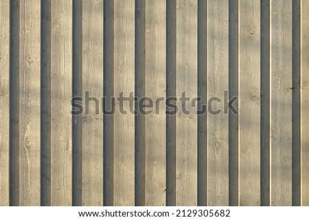 Light brown wooden boards (siding) close-up. Texture, pattern, background, wallpaper. Lumber industry, constructing, furniture and other graphic resources concepts. Panoramic image