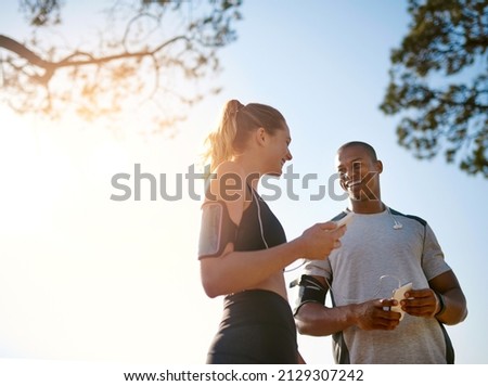 Buddy up for the best. Shot of a fit young couple working out together outdoors. Royalty-Free Stock Photo #2129307242