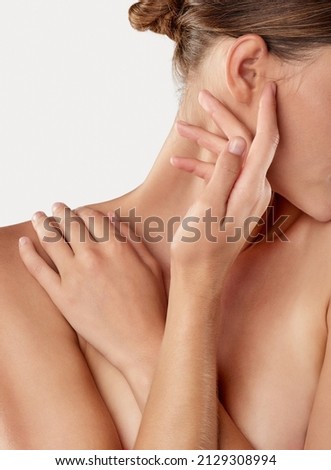 Reveling in her softness. Closeup studio shot of a beautiful young woman caressing her skin. Royalty-Free Stock Photo #2129308994