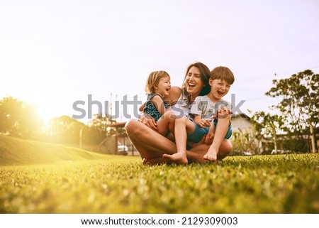 Her boys fill her life with joy. Cropped shot of a young family spending time together outdoors. Royalty-Free Stock Photo #2129309003