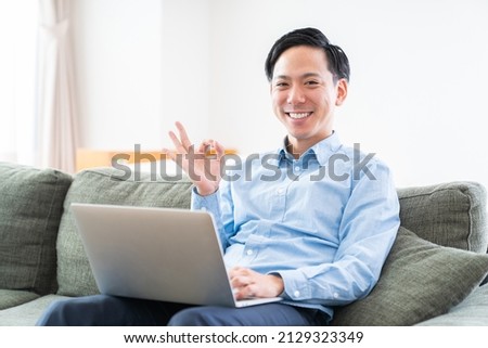 Asian young man  using laptop