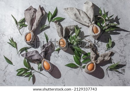 Festive easter background with Easter bunny eggs on linen napkin. Easter decoration, top view. Copy space.